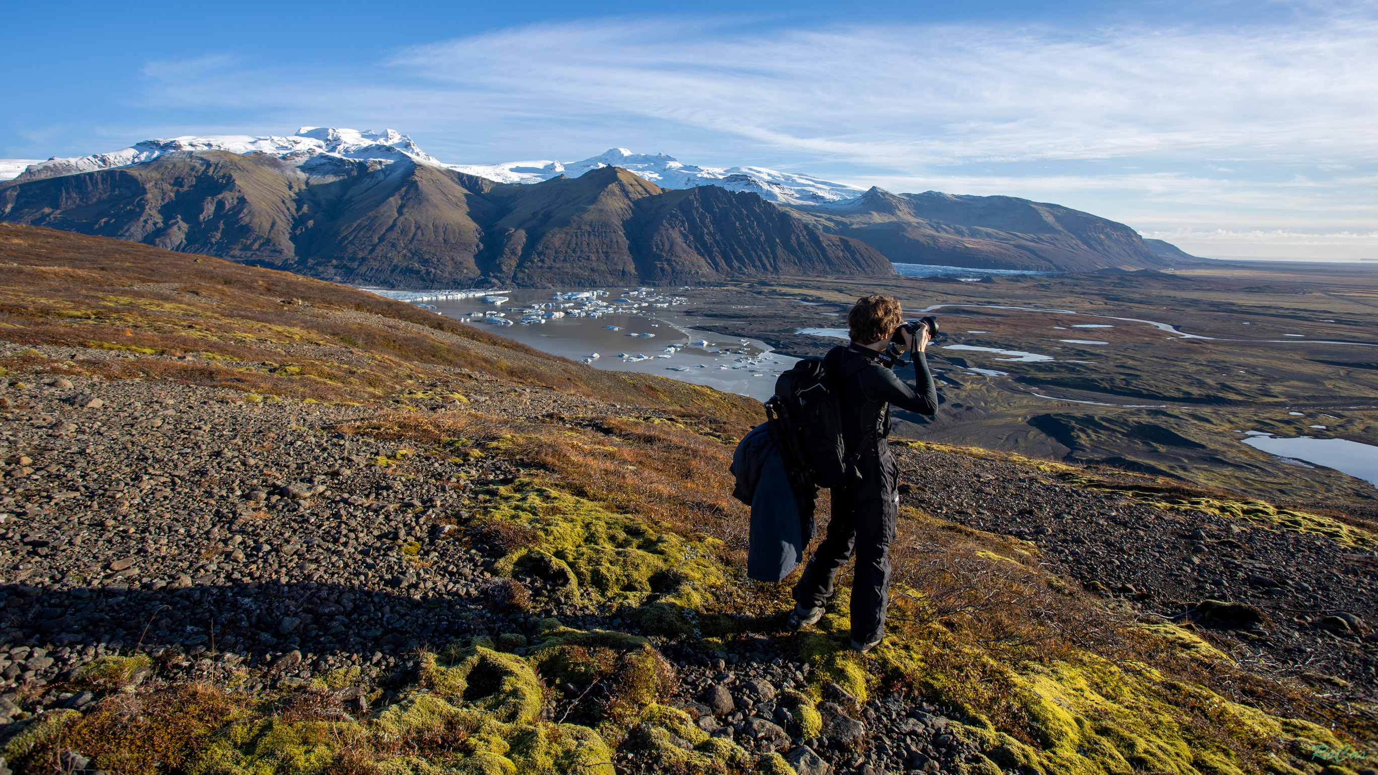 Bastien photographing above a glacier valley in Iceland