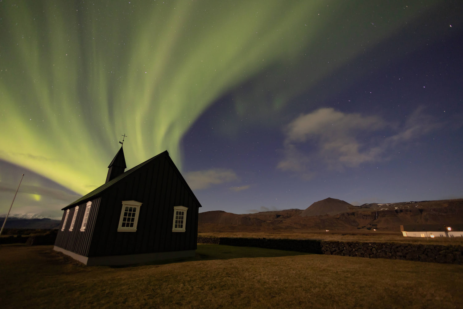 Northern lights over the black church of Búðir, Snæfellsnes