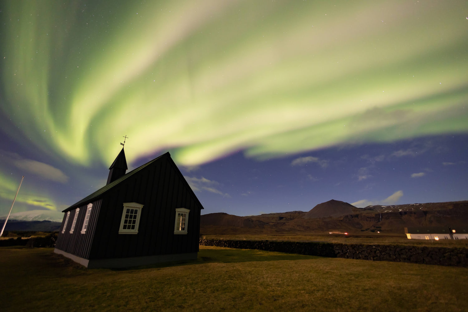 Northern lights over the black church of Búðir, Snæfellsnes