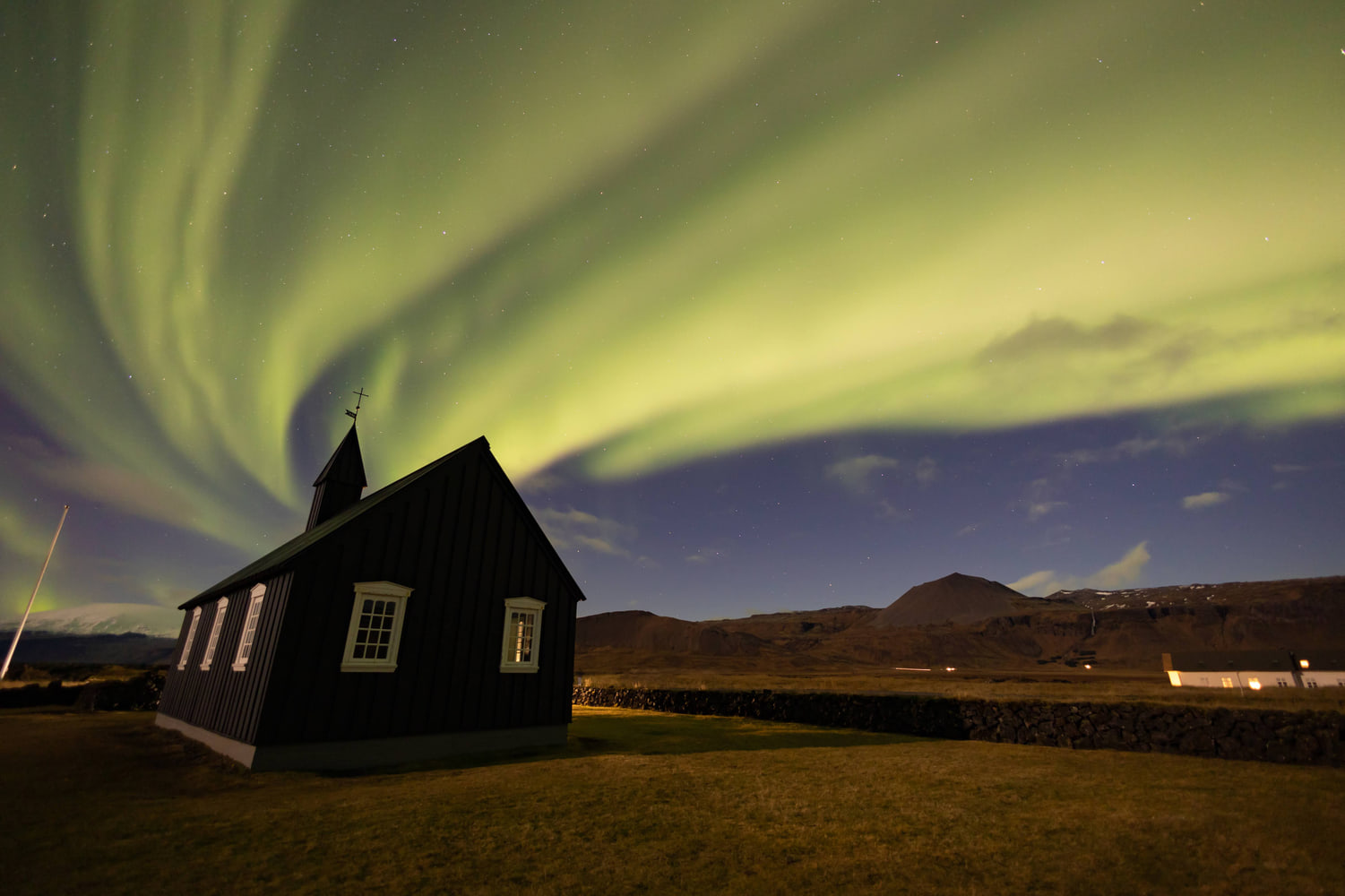Northern lights over the black church of Búðir, Snæfellsnes