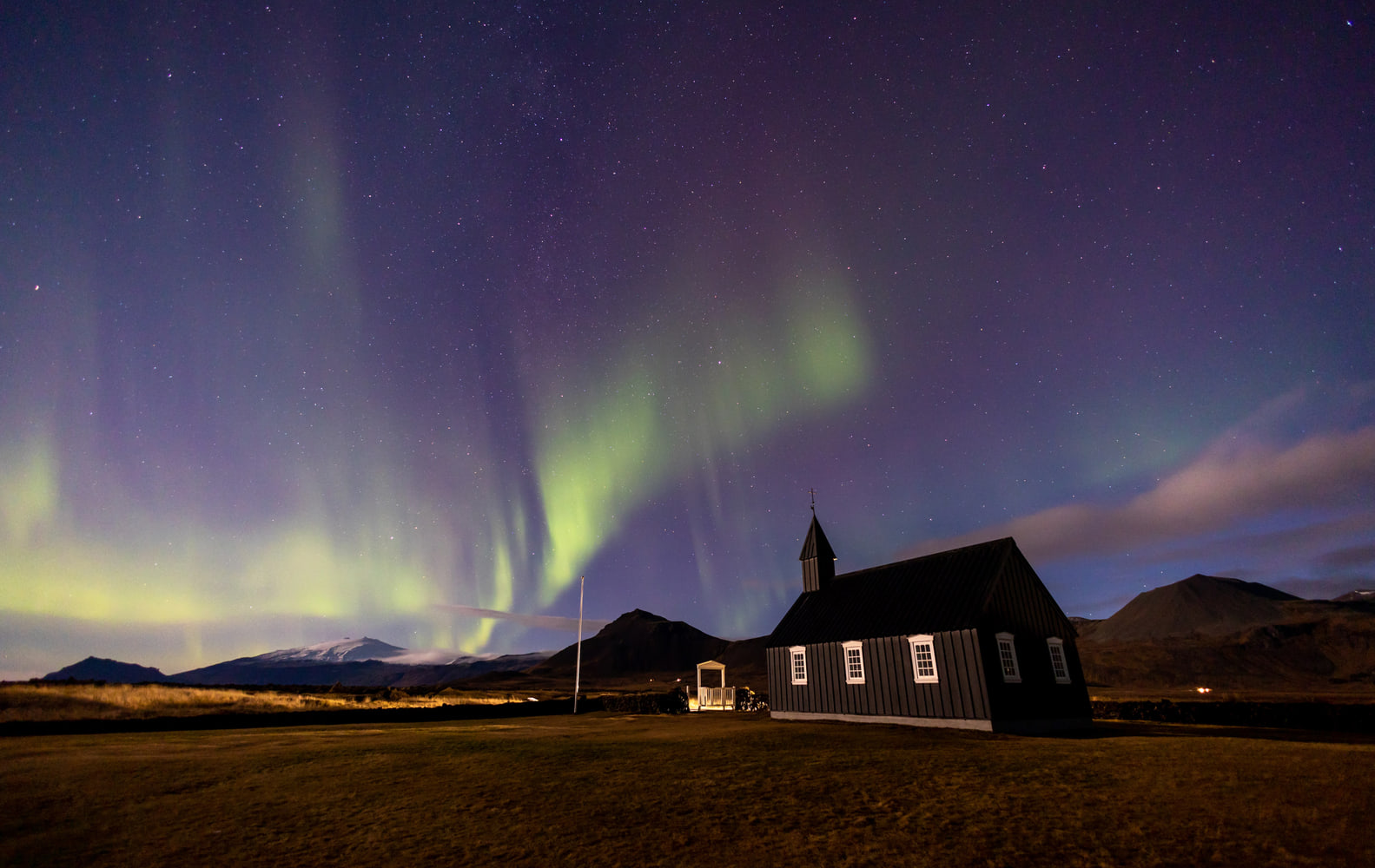 Northern lights over the black church of Búðir, Snæfellsnes