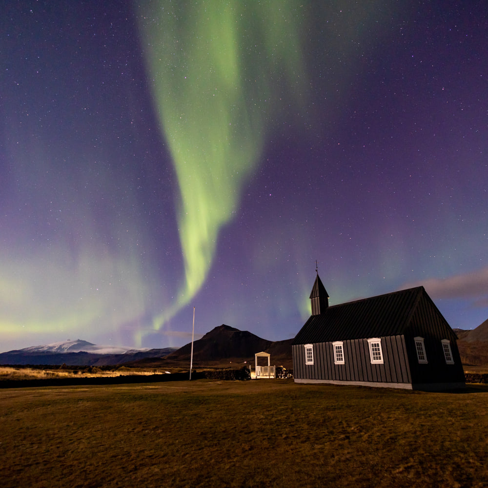 Northern lights over the black church of Búðir, Snæfellsnes